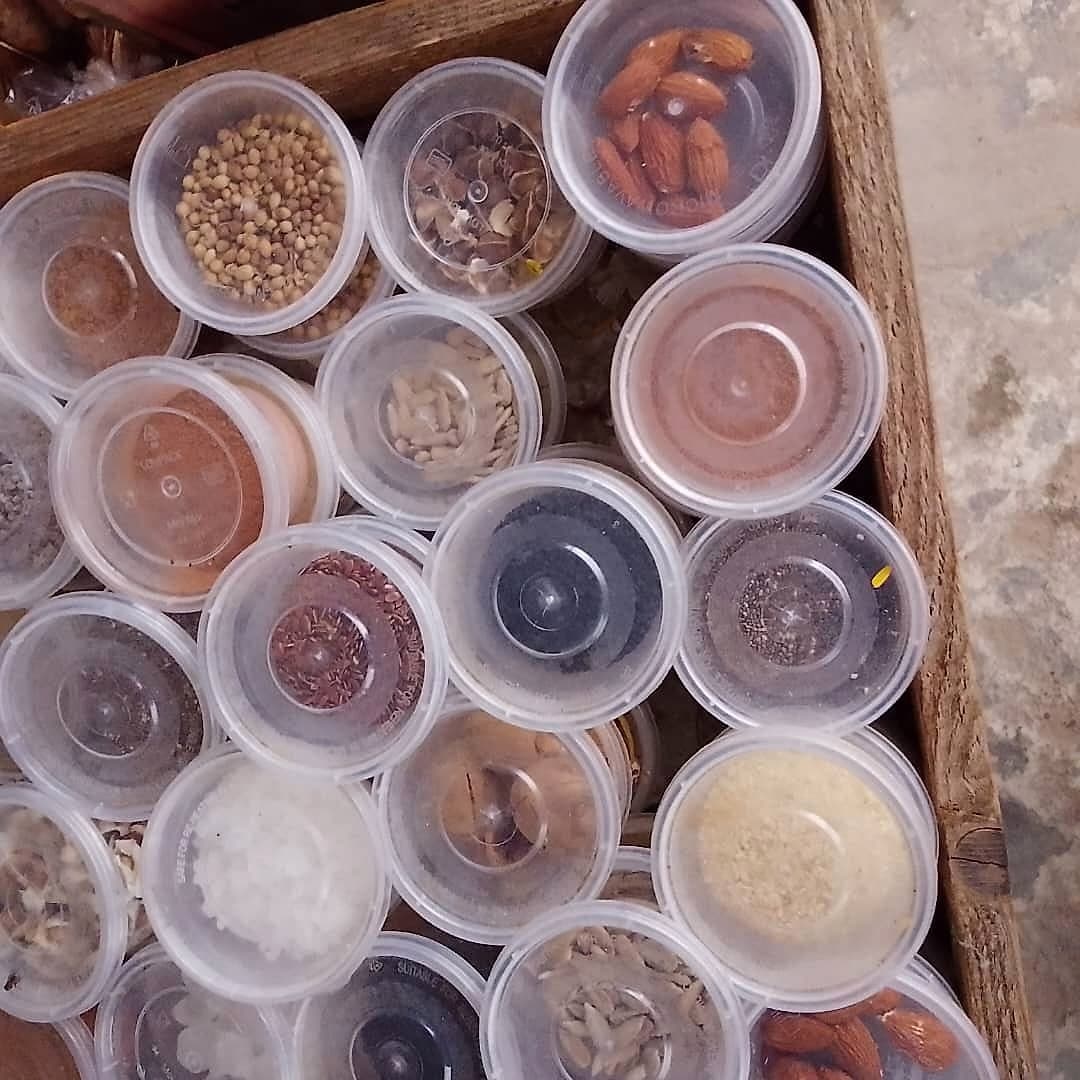 A wooden crate of packaged spices and dried okro