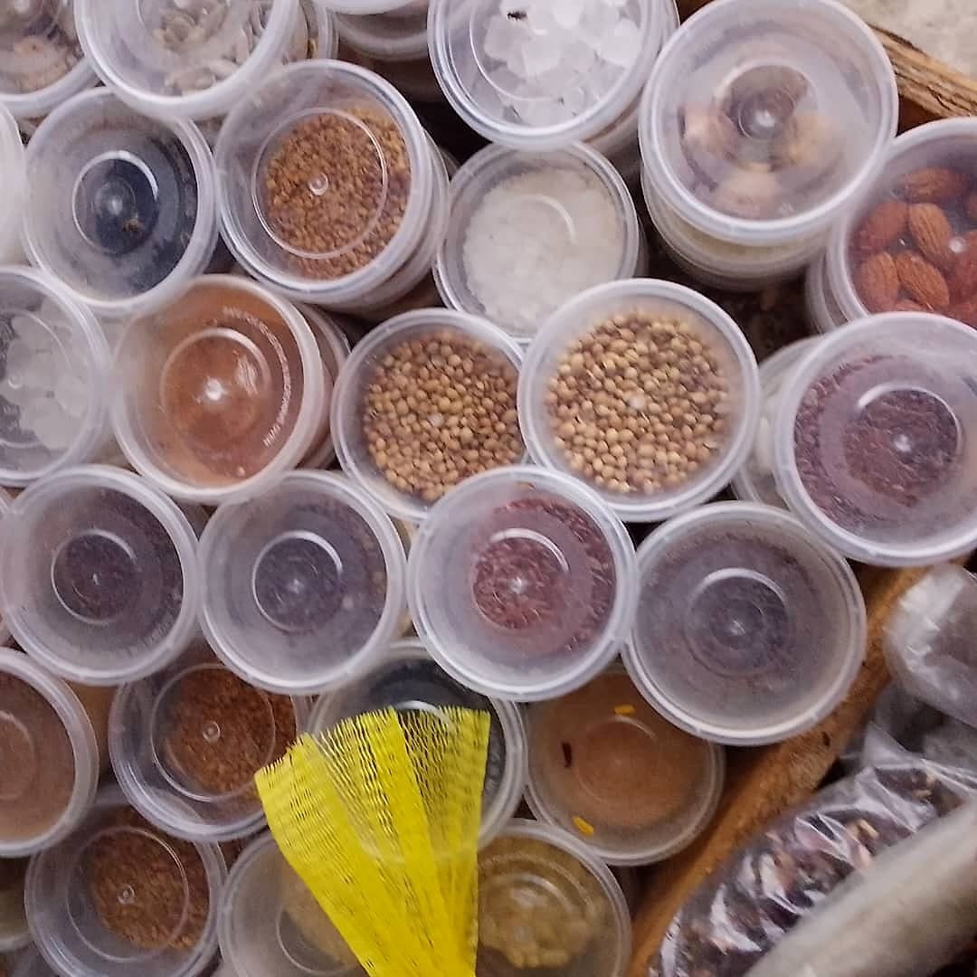 Packed tubs of ground spices and whole seeds